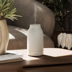White diffuser on a wooden surface with a blurred background