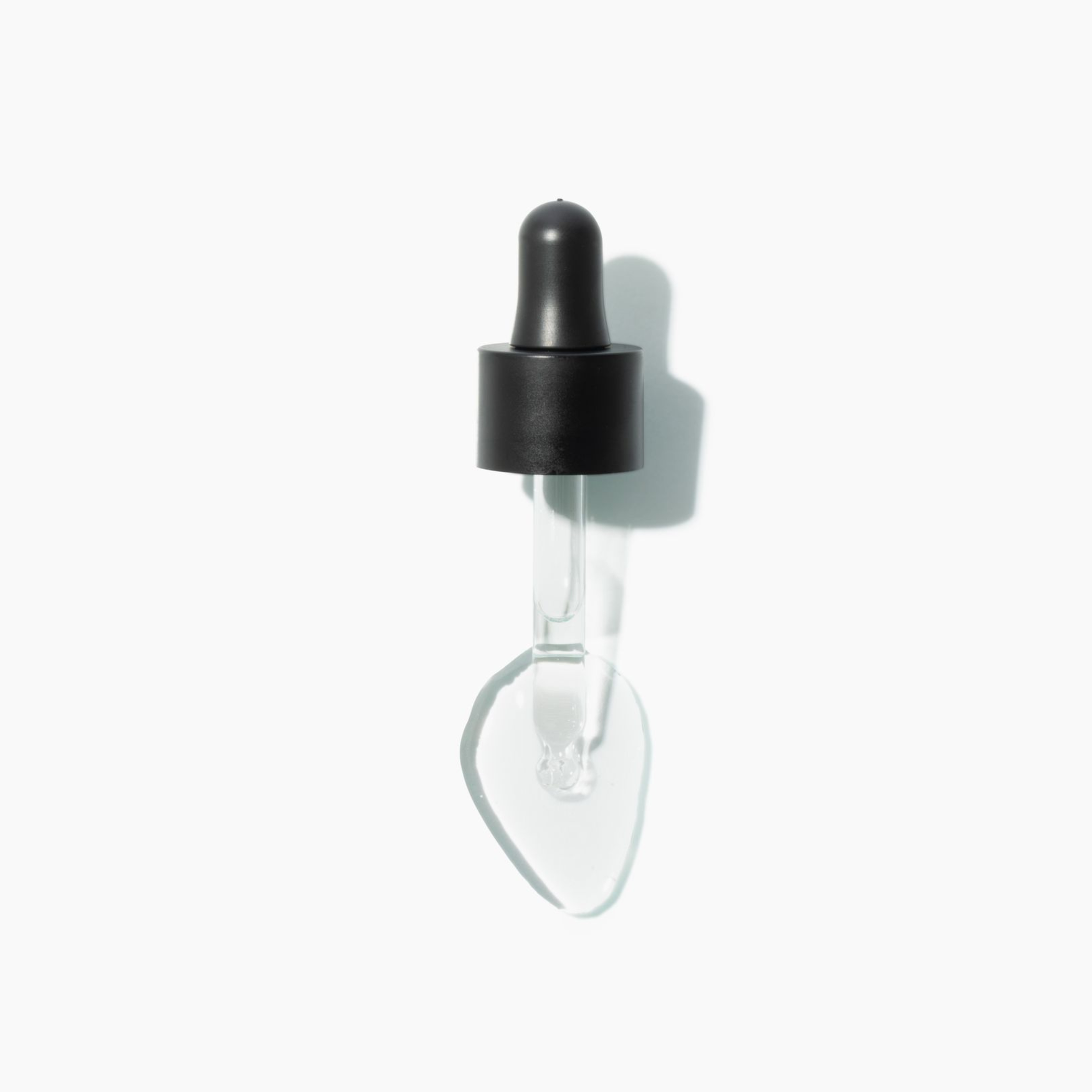 Bottle and box of TEN OVER TEN nail dryer drops on a white background
