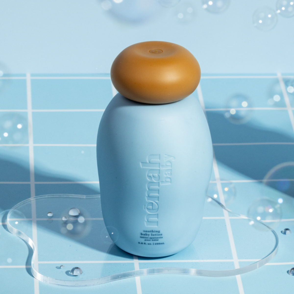 A blue bottle with a brown lid on light blue tiles. 