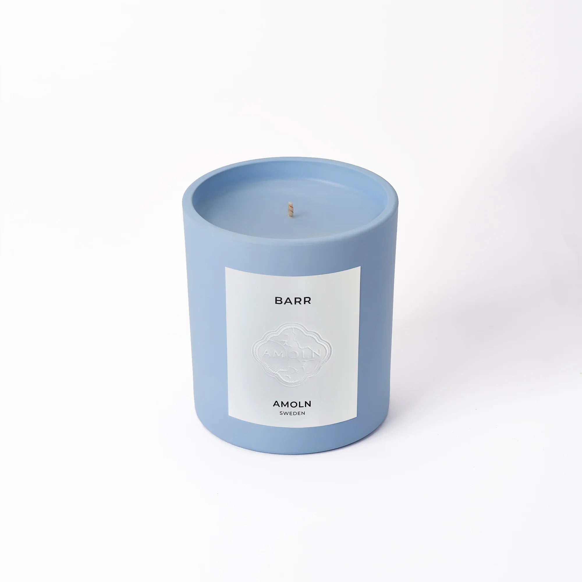 A blue candle with a label that reads 'BARR' and 'AMOLN' on a white background.