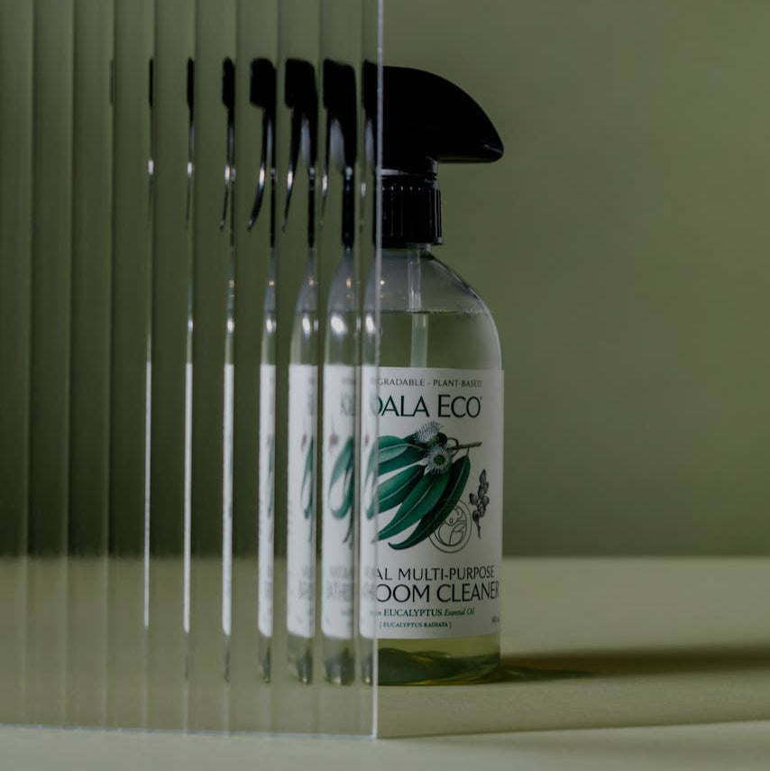 A clear spray bottle labeled Koala Eco Natural Multi-Purpose Bathroom Cleaner with a green leaf design.