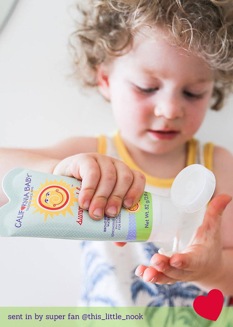 Child holding a California Baby sun screen bottle with a heart and text overlay