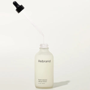 Skincare bottle labeled 'Rebrand' on a white background
