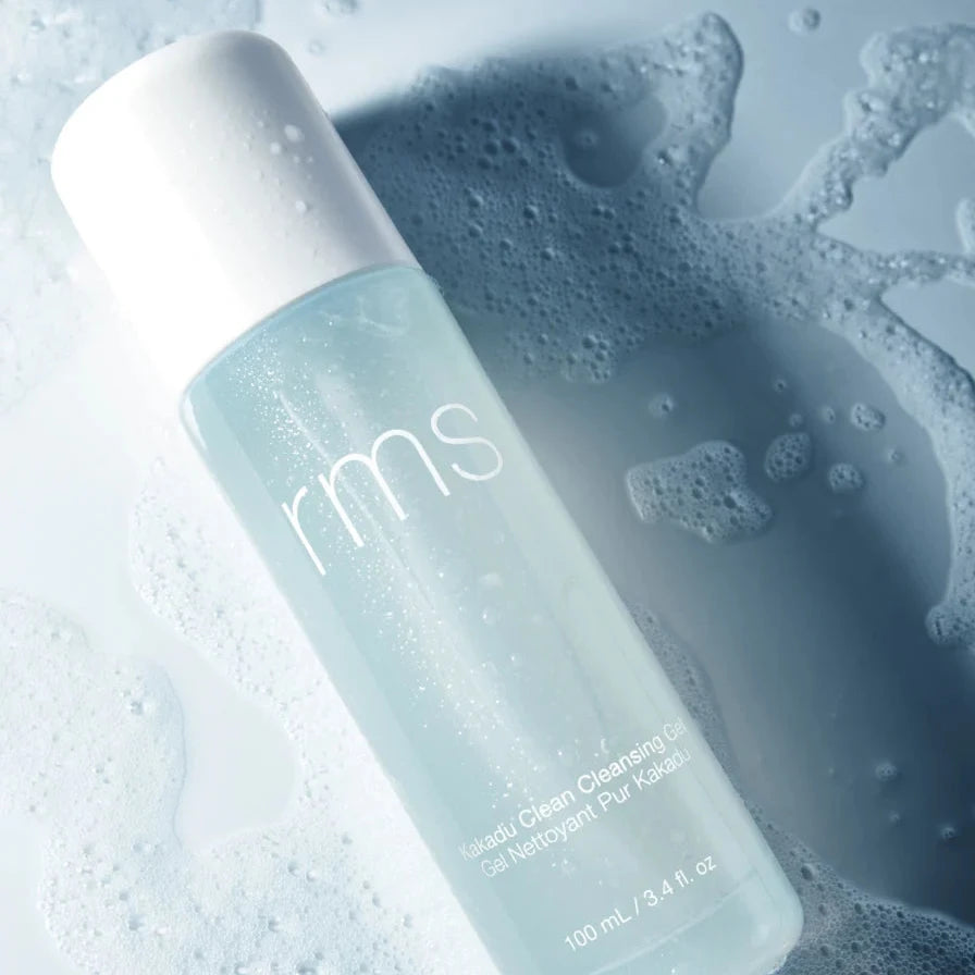 A light blue bottle of RMS Kakadu clean cleansing gel, with a white top