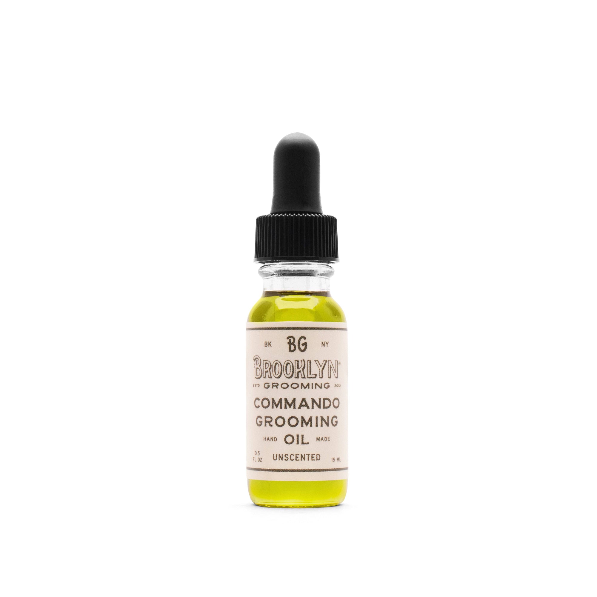 A bottle of Brooklyn Grooming Commando Grooming Oil with a dropper cap.