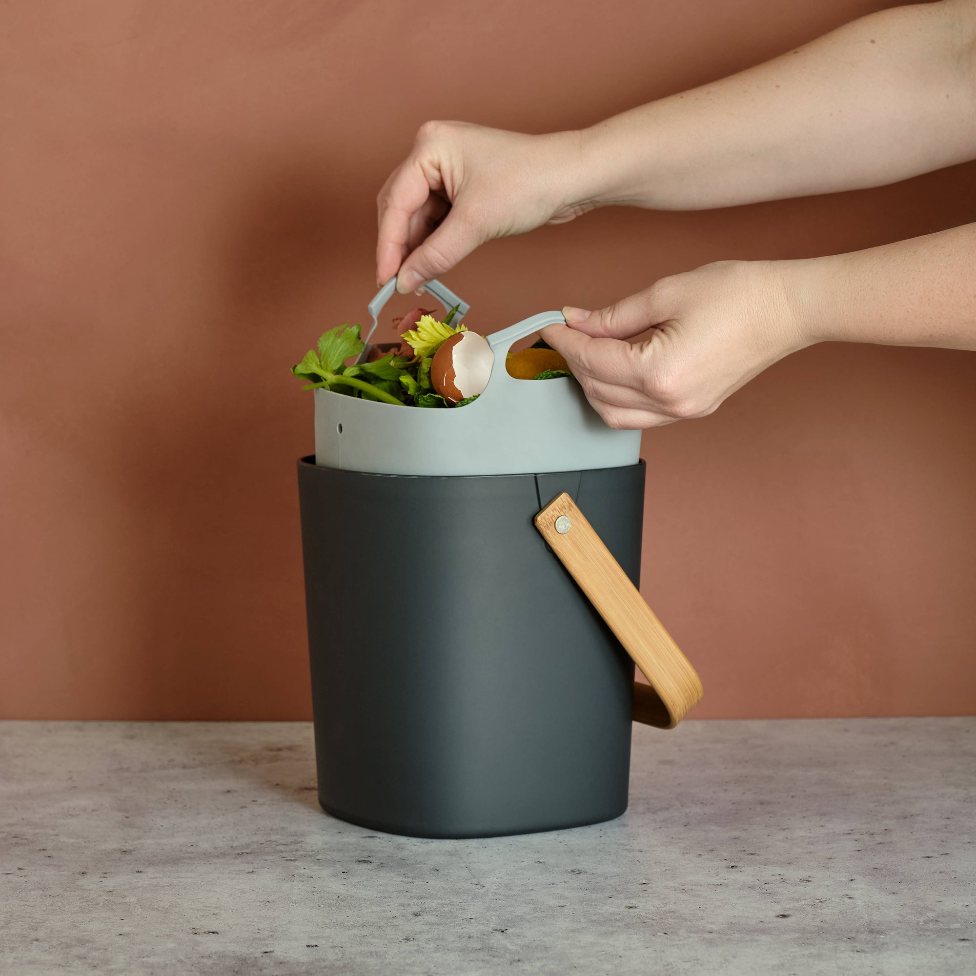 A grey composter liner on a grey surface. 