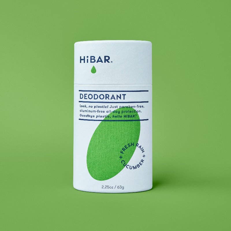 A tube of hi bar fresh rain cucumber deodorant on a green background. 