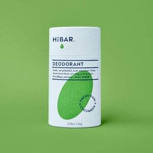 A tube of hi bar fresh rain cucumber deodorant on a green background. 