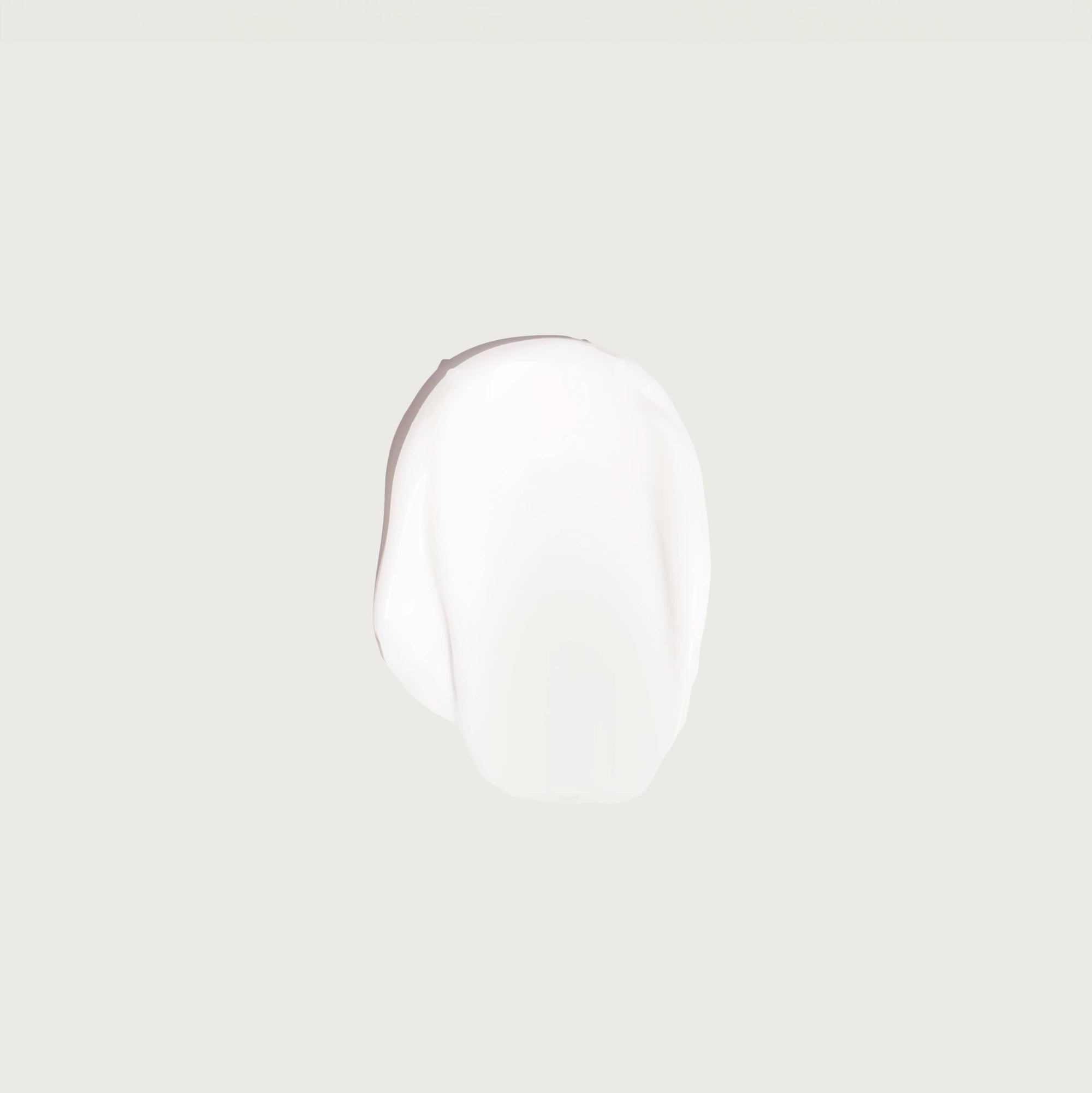 A sample of Rebrand Day & Night Cream on a light gray background