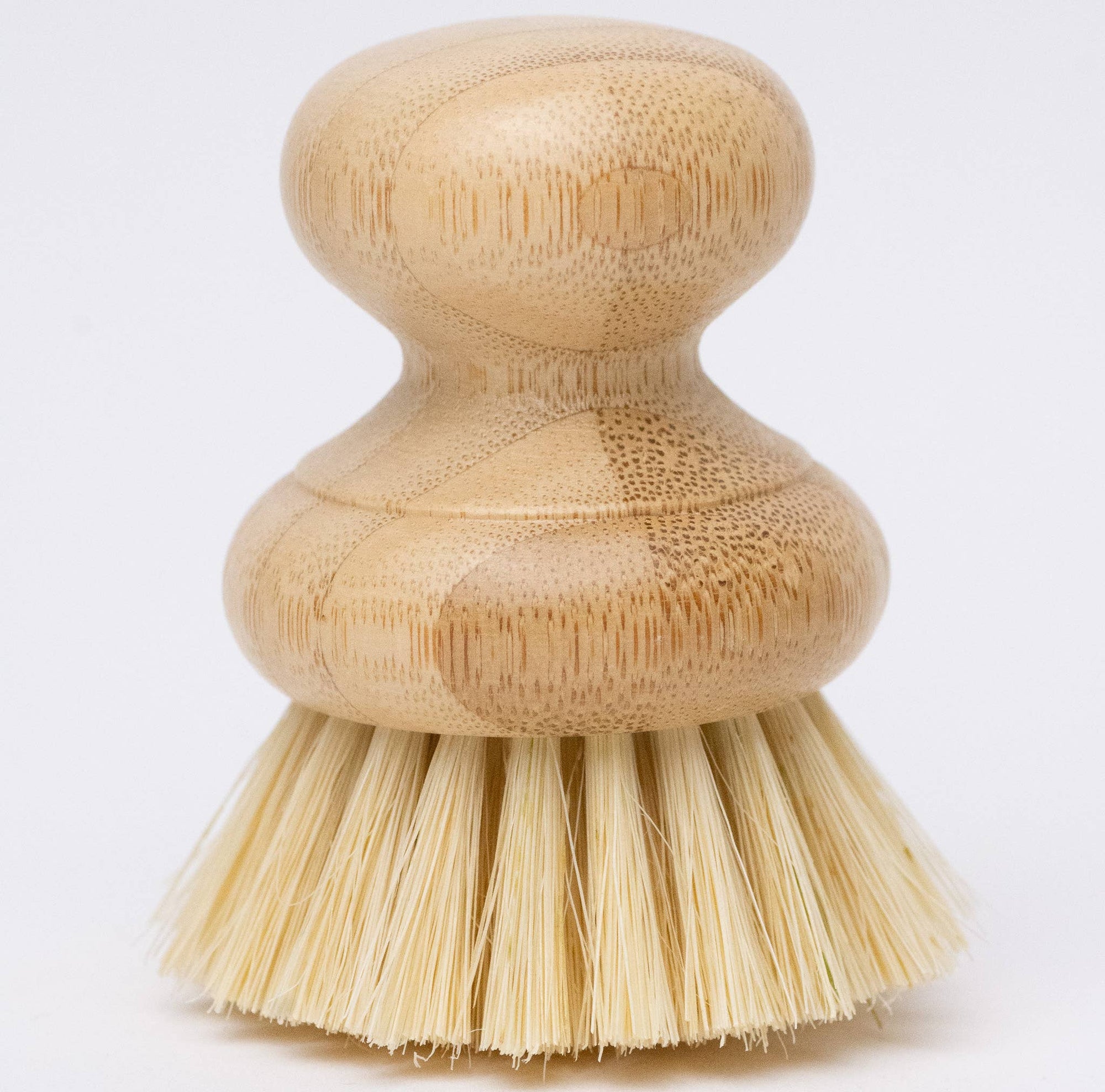 A beige dish washing brush with a bamboo handle and agave fiber bristles.