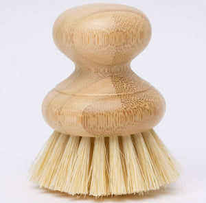 A beige dish washing brush with a bamboo handle and agave fiber bristles.