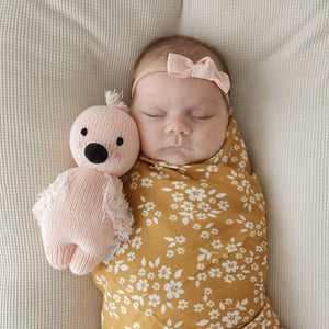 The Cuddle and Kind baby flamingo stuffed animal gives five meals to children in need when purchased
