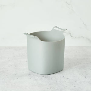 A grey composter liner on a grey surface. 