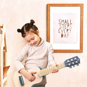 The Speedy Monkey blue toy guitar, being played by a child