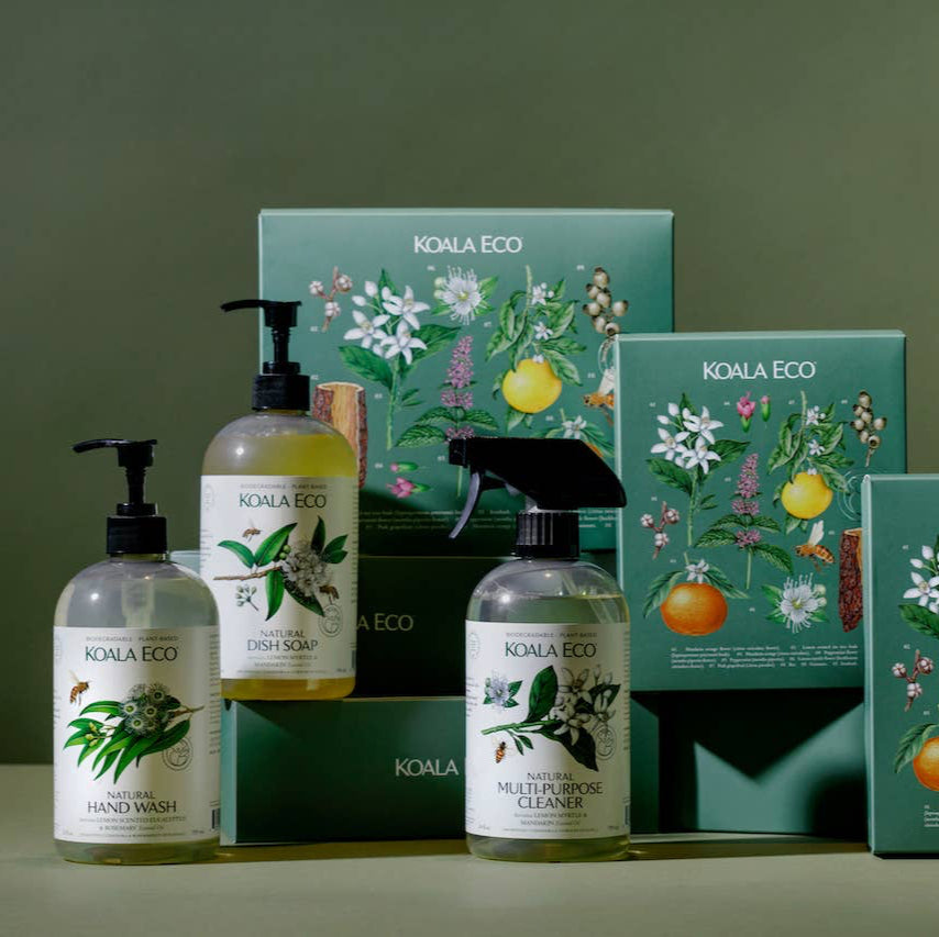 A set of Koala Eco cleaning products including hand wash, dish soap, and multi-purpose cleaner, presented in a botanical-themed packaging.