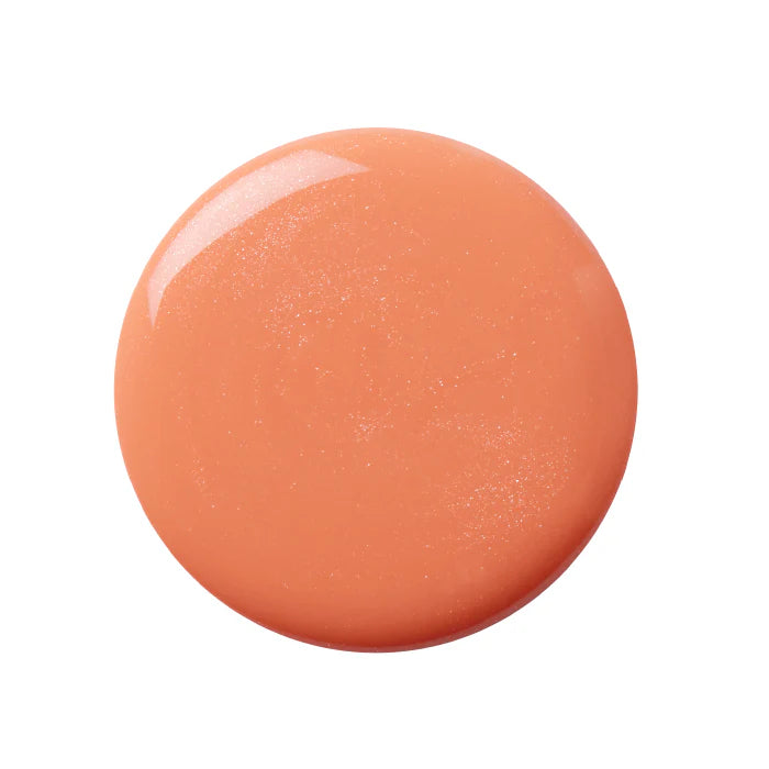 A bottle of Kure Bazaar nail polish in a peachy coral color with a translucent finish, labeled in Paris.