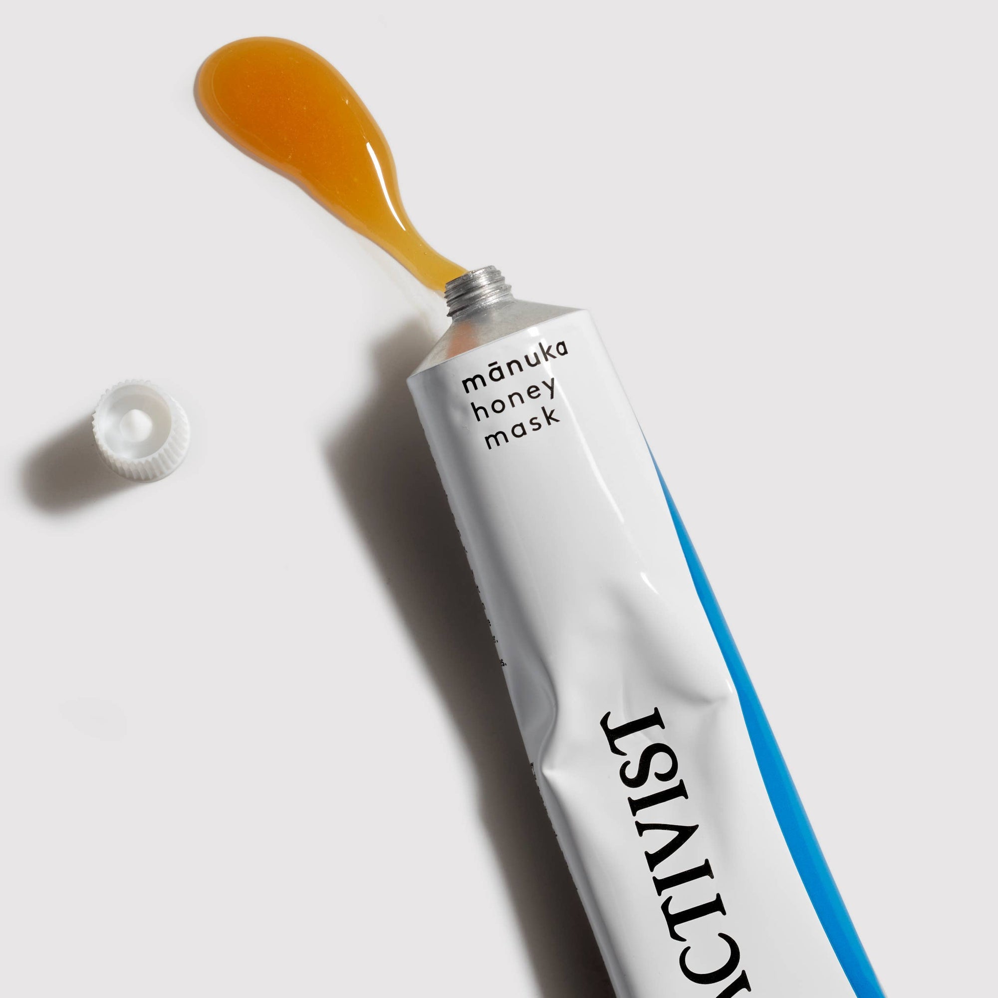 Activist manuka honey mask tube and packaging on a white background