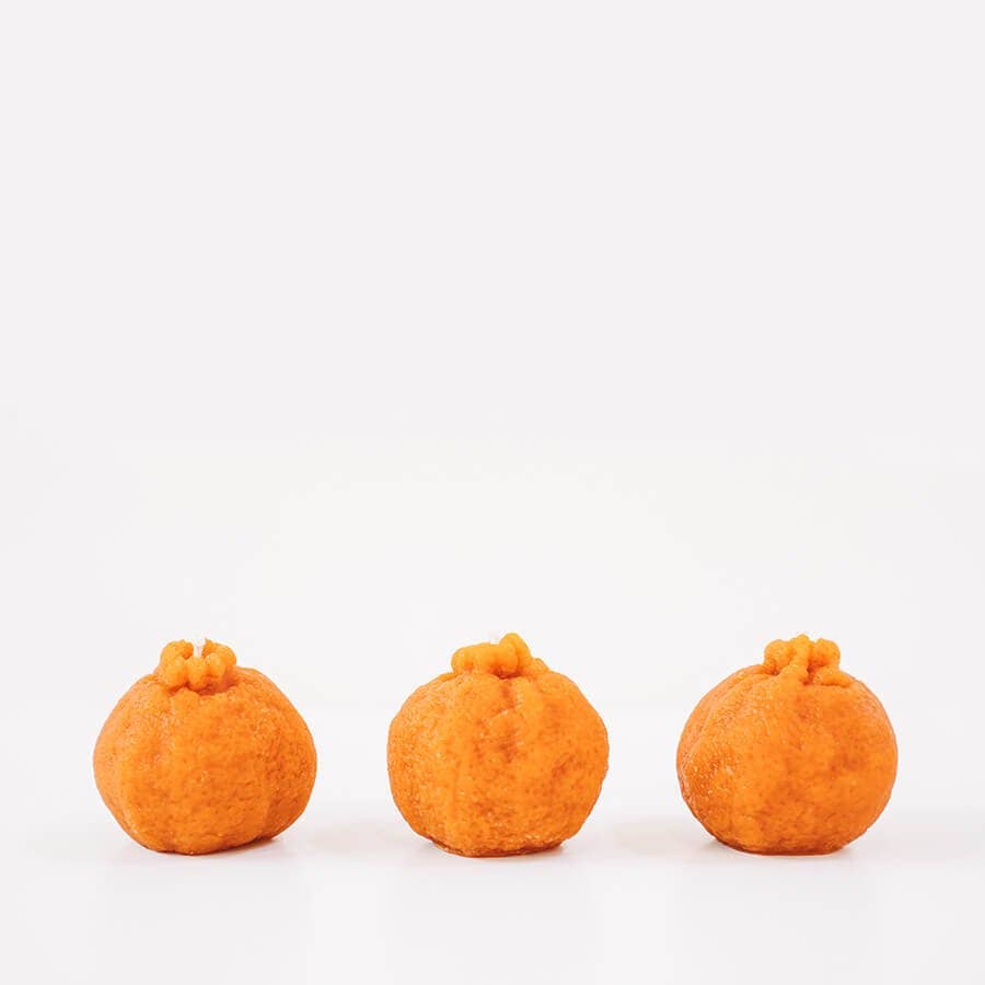 Happy Organics orange candle, hand made and organic.