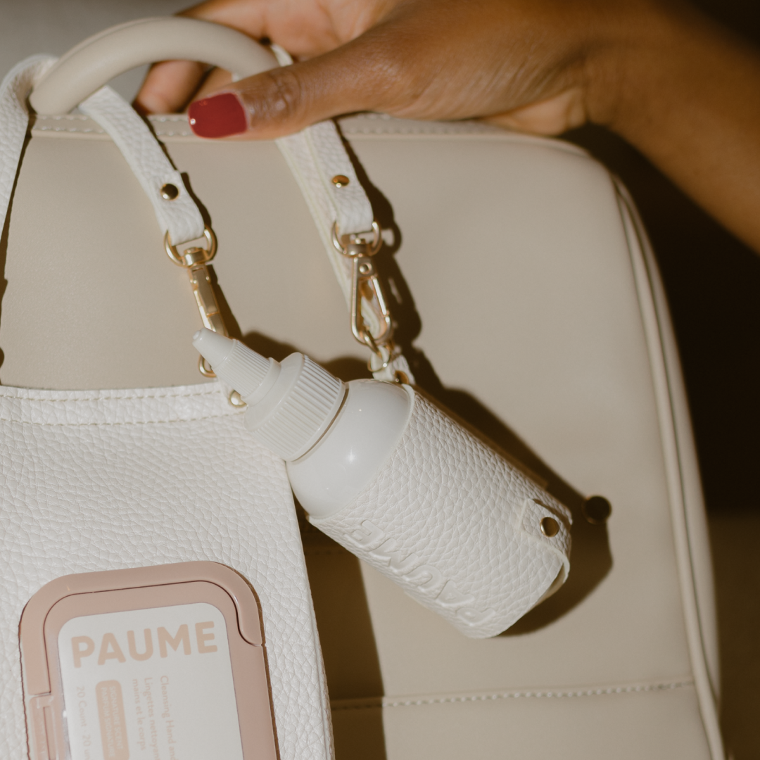 White textured handbag with a strap on a beige background