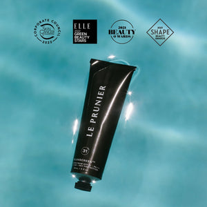 A tube of Plumscreen by Le Prunier on a water background. 