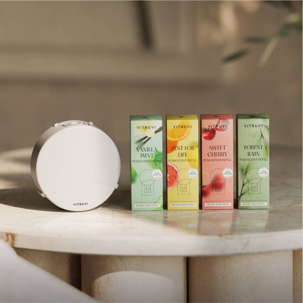 Vitruvi diffusers and packaging on a marble surface