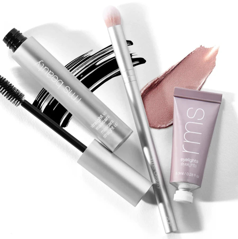 A collection of makeup brushes and products including an eye pencil, a brush with imitation goat hair, a tube of cream shadow, and a compact powder.