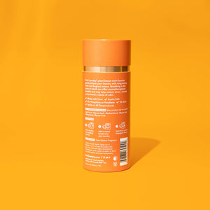 A bottle of Kind Laundry scent boosters on an orange background. 