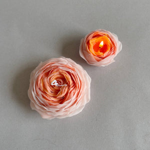 Two floral candles on a gray background