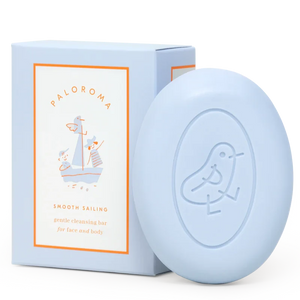 Light blue soap bar with packaging on a white background
