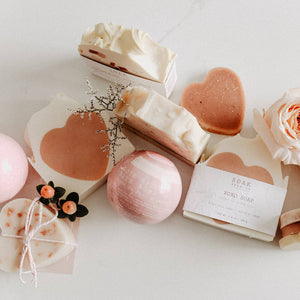 A group of soak products, including the xoxo soap and bath bombs