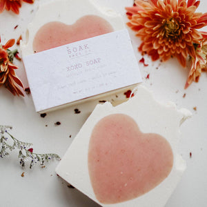 Two bars of soak xoxo soap, with orange flowers
