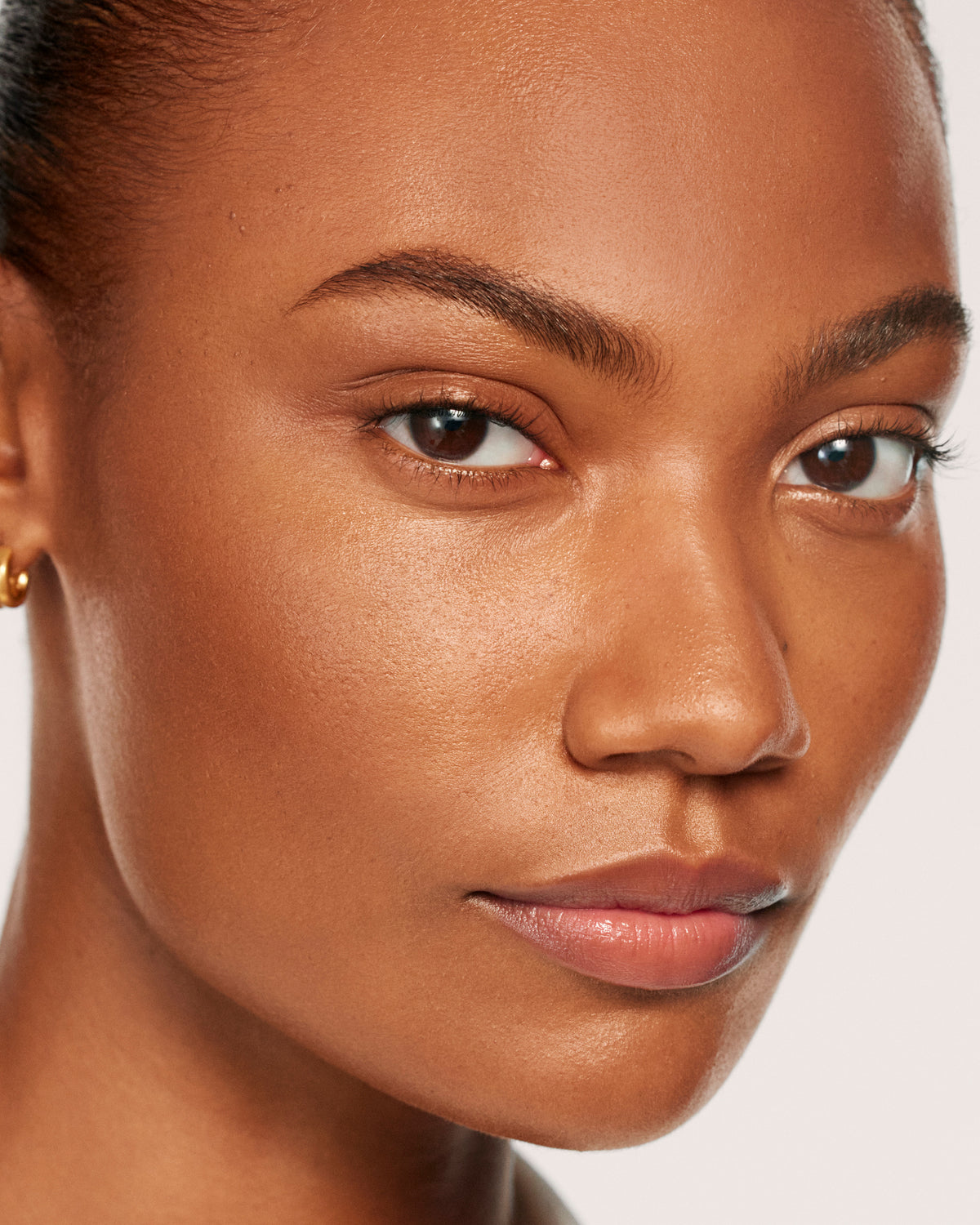 Close-up of a woman's face with a neutral background