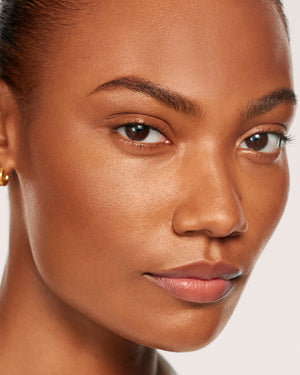 Close-up of a woman's face with a neutral background