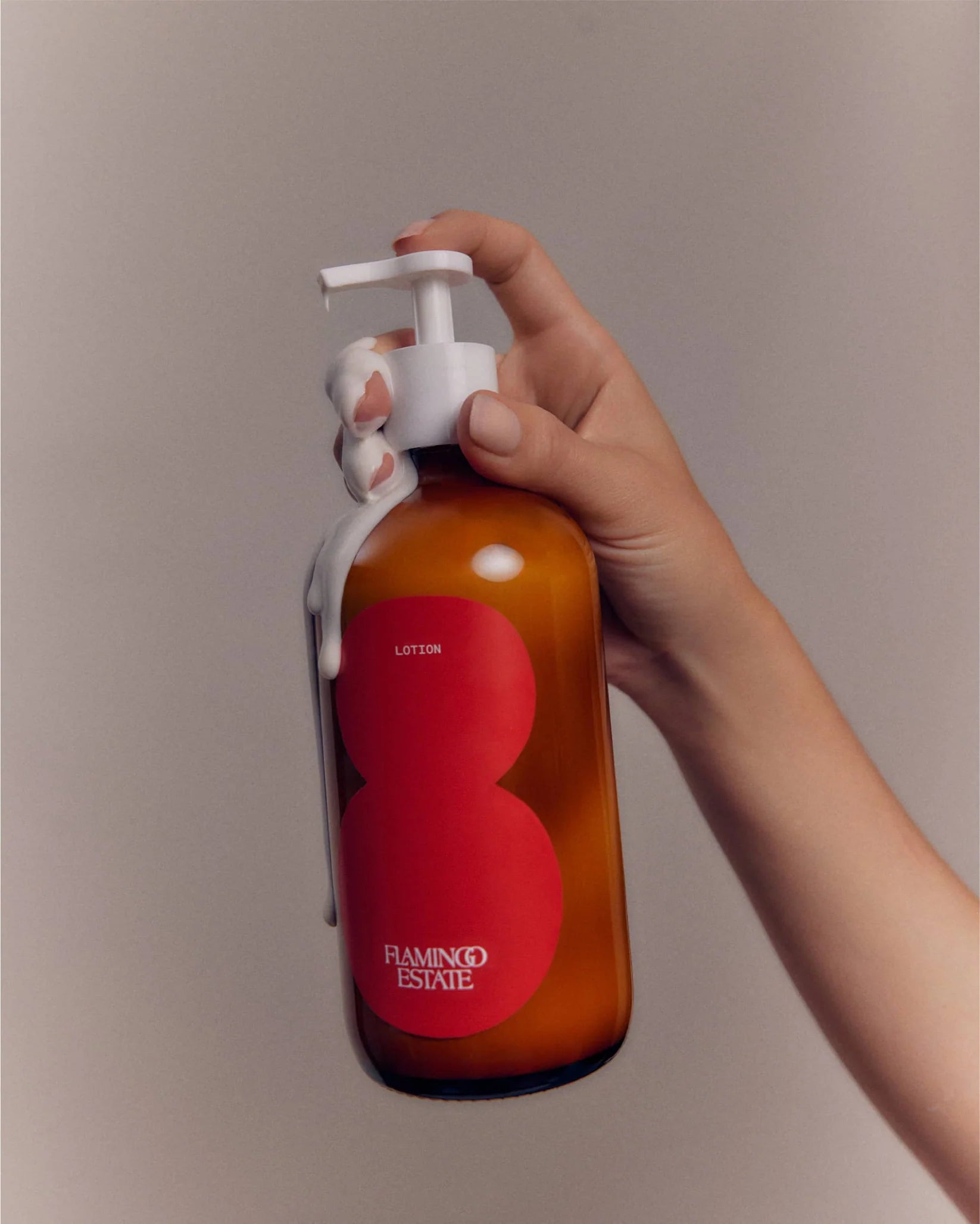 Flamingo Estate tomato lotion, in a brown glass bottle with a white top