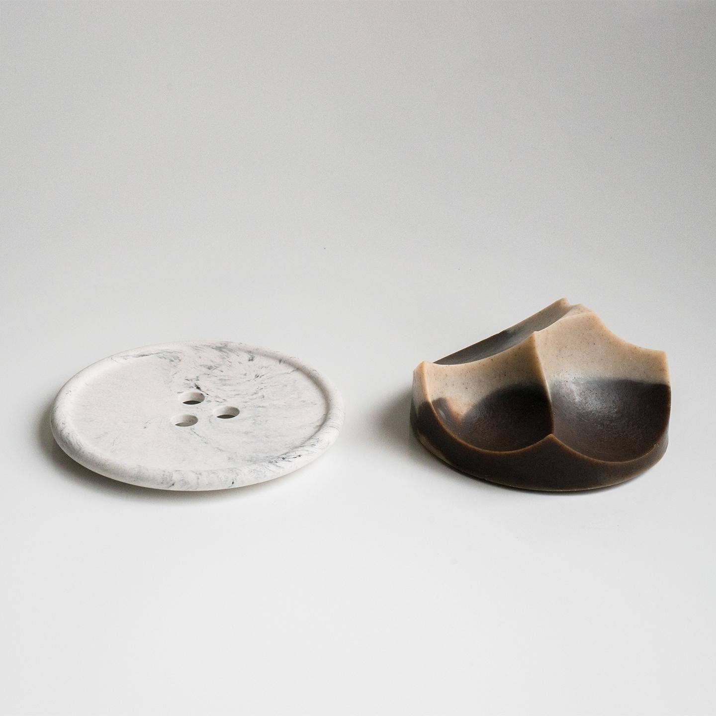 A brown ume studios soap with a grey bouton. 