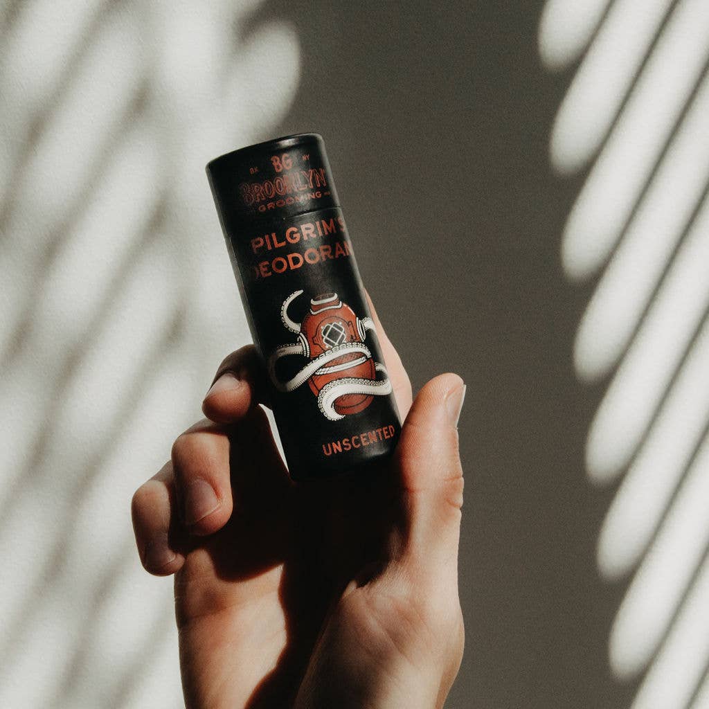A stick deodorant labeled 'Pilgrim’s Deodorant' with the word 'UNSCENTED' printed on the cap, indicating the fragrance-free variant of the product.