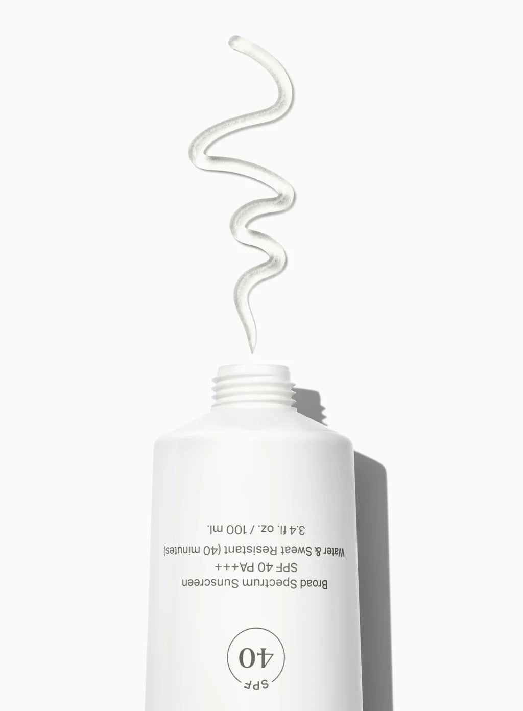 A white bottle of unseen sunscreen with a swatch of clear gel