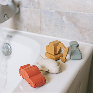 Vehicle bath toys placed on the side of the bathtub