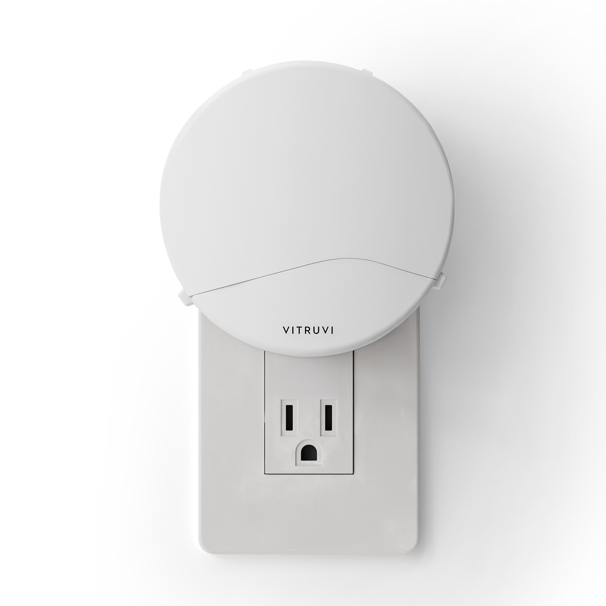 White plug in diffuser attached to a wall outlet with 'Vitruvi' branding on a white background