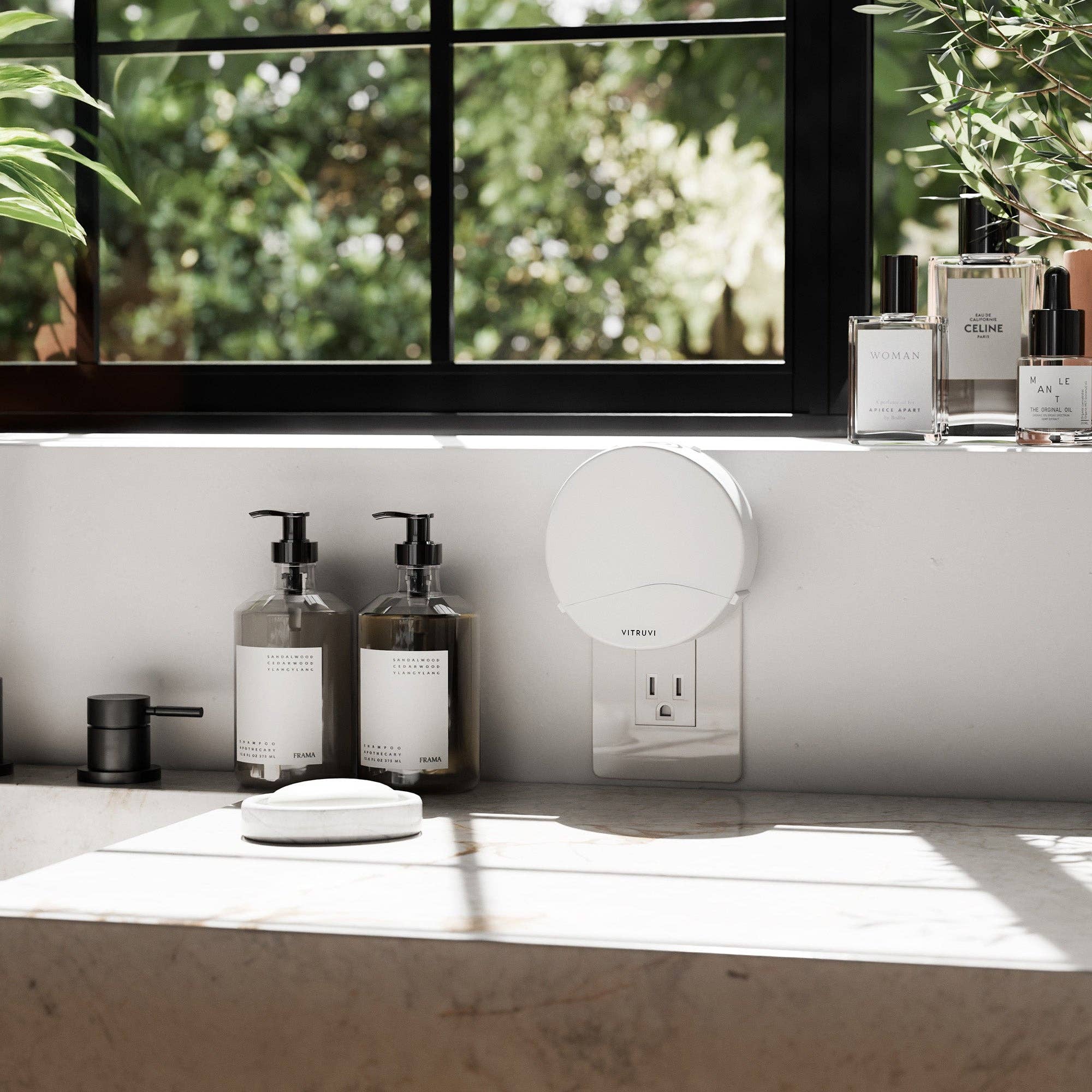 A kitchen counter with a vitruvi diffuser plugged into the wall