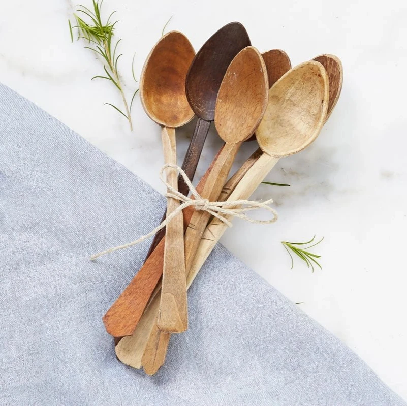 Six Found Wooden Spoons, on a white surface. 