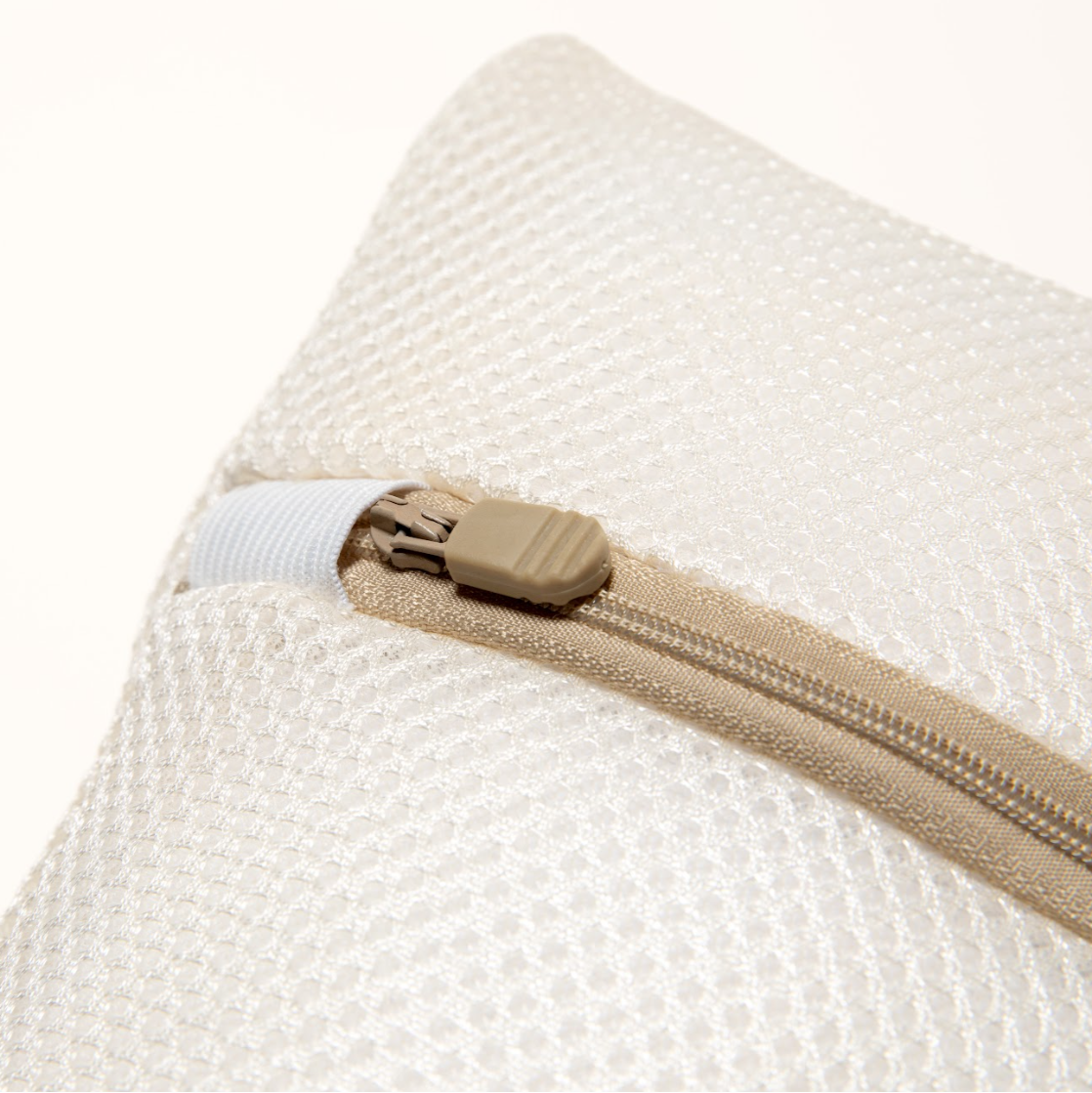 A white premium washable mesh laundry bag with a zipper handle, featuring the 'Kind Laundry' brand logo on the front.
